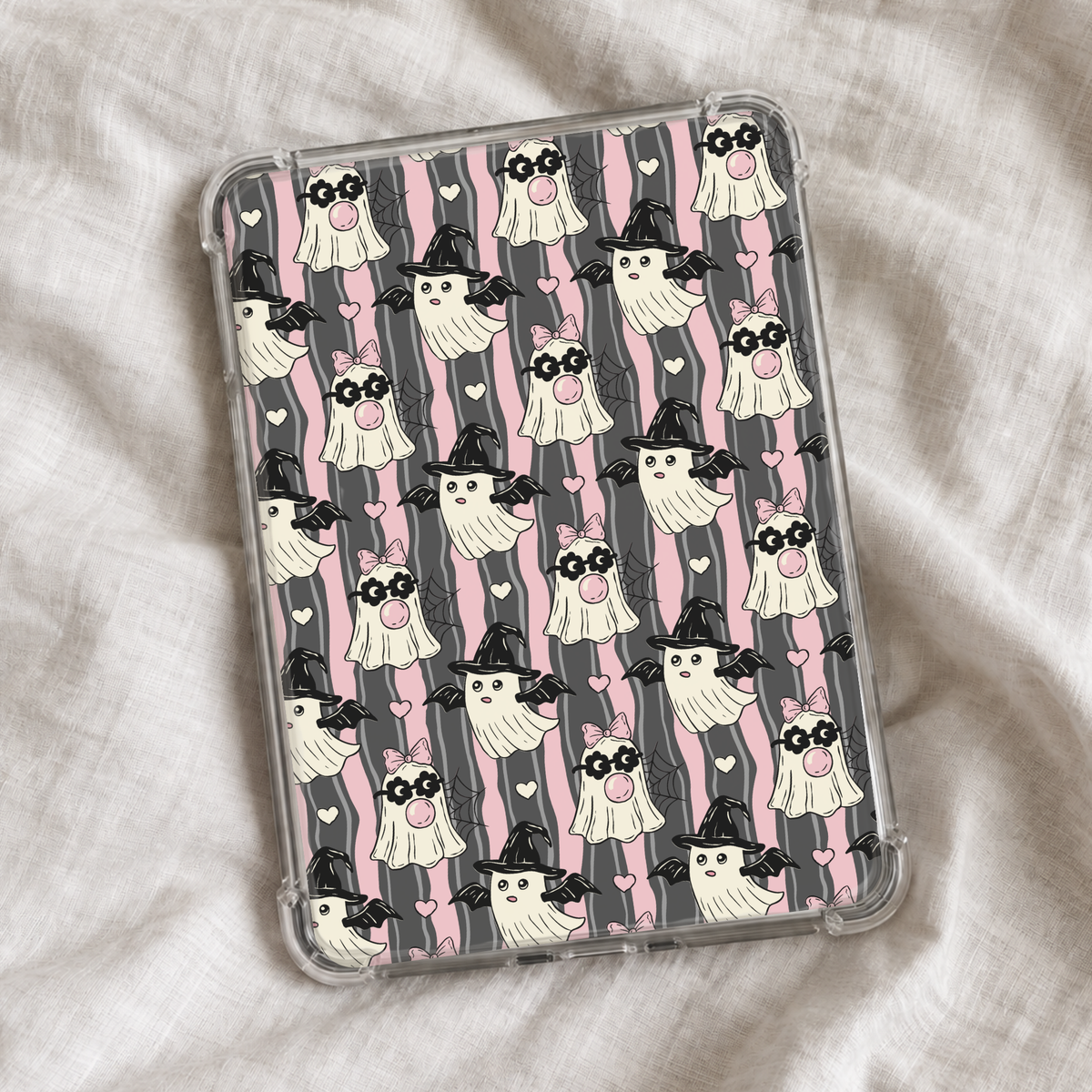 Cute girly Halloween Kindle insert featuring playful ghosts in witch hats, pink bows, hearts, bats, and spiderwebs on a wavy pink and charcoal striped background.