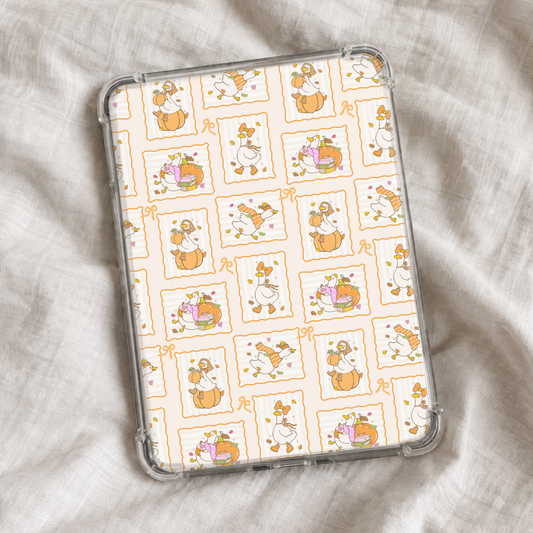 Cute autumn Kindle insert featuring whimsical geese with pumpkins, cozy sweaters, fall leaves, books, and seasonal accessories arranged in orange scalloped frames with dainty bow details.
