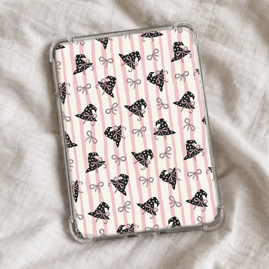 Girly Halloween Kindle insert featuring soft pink and cream vertical stripes with black polka-dot witch hats decorated with pink bows and scattered dainty bow details.